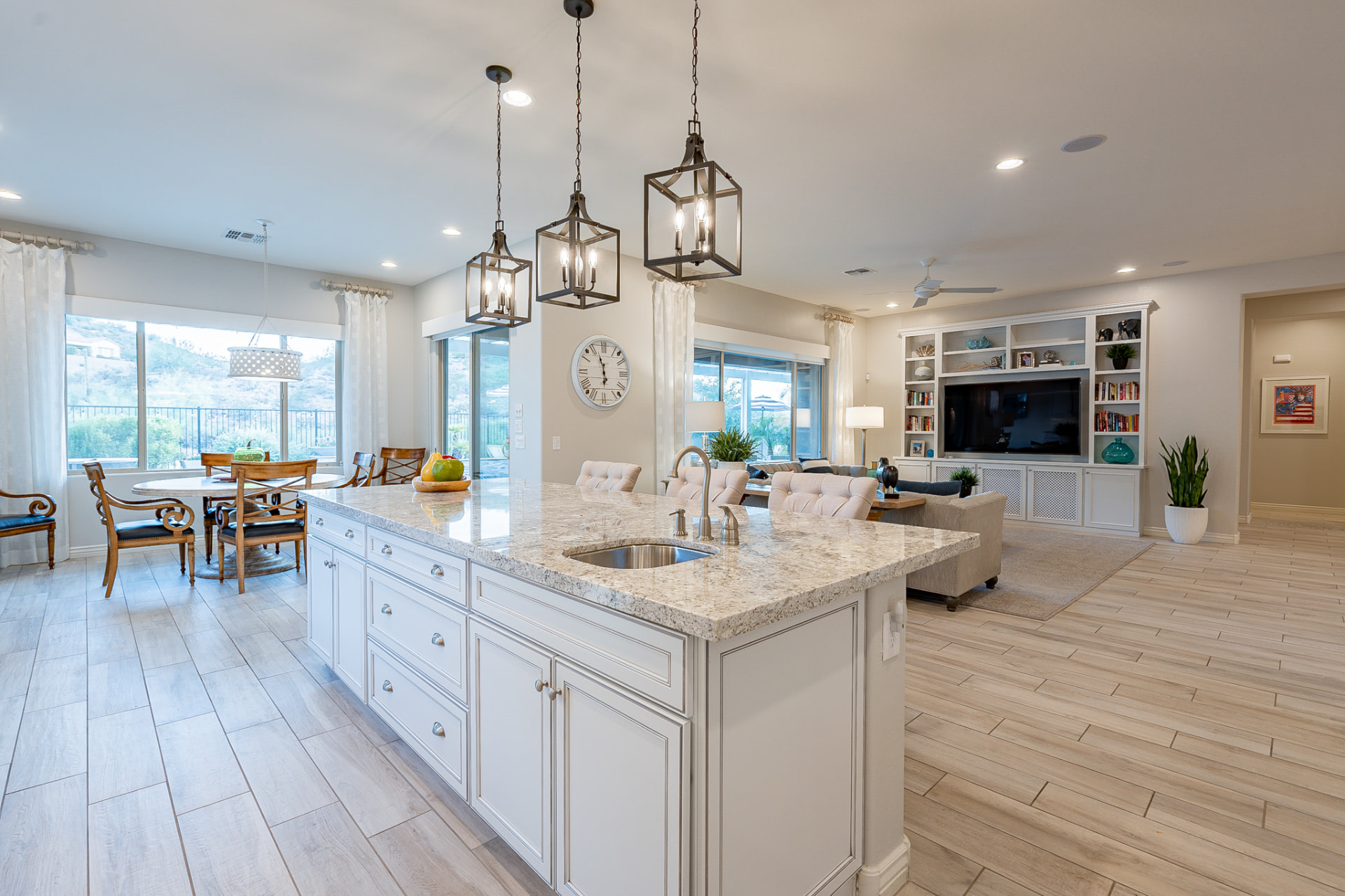 Open-concept kitchen with granite island and mountain views